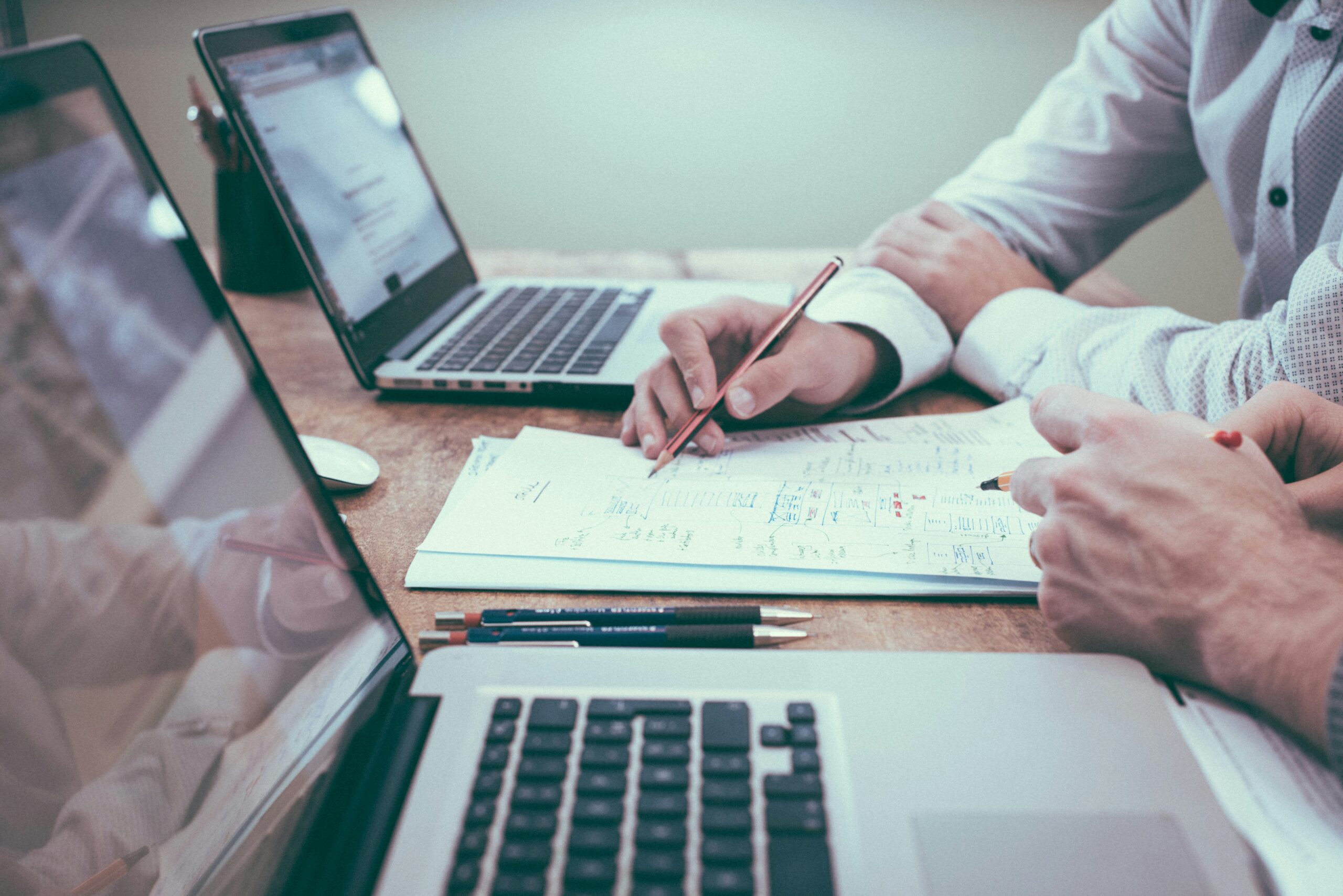 Accounting and finance professionals working with documents and laptop